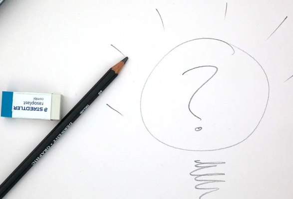 Feuille de papier sur laquelle sont posés une gomme et un crayon mine et est dessinée une bulle avec un point d'interrogation à l'intérieur